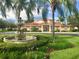 Community center with a fountain, lush landscaping, and ample parking at 1130 Villagio Cir # 203, Sarasota, FL 34237