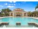 Large community pool with a clubhouse and lounge chairs at 1130 Villagio Cir # 203, Sarasota, FL 34237