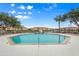 Community pool with a water feature and lounge chairs at 1130 Villagio Cir # 203, Sarasota, FL 34237