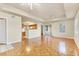Living area with parquet flooring, ceiling fan, sliding glass door to balcony, and a view of the kitchen at 1130 Villagio Cir # 203, Sarasota, FL 34237