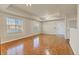 Open living area with parquet flooring, ceiling fan, and access to the kitchen and front door at 1130 Villagio Cir # 203, Sarasota, FL 34237