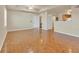 Spacious living area with parquet flooring, ceiling fan, and a view into the kitchen and hallway at 1130 Villagio Cir # 203, Sarasota, FL 34237