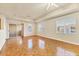Living room with parquet floors, ceiling fan, large windows, and sliding glass doors to the balcony at 1130 Villagio Cir # 203, Sarasota, FL 34237