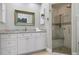 Elegant bathroom featuring a walk-in shower and granite countertop at 116 50Th St, Holmes Beach, FL 34217