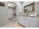 Bright bathroom with white cabinets and a granite countertop at 116 50Th St, Holmes Beach, FL 34217