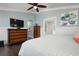 Spacious bedroom with wood floors, large TV, and dresser at 116 50Th St, Holmes Beach, FL 34217