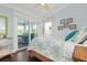 Bedroom with a bed, dresser, and access to a porch swing at 116 50Th St, Holmes Beach, FL 34217