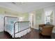 Bedroom with a metal bed frame and wicker chair at 116 50Th St, Holmes Beach, FL 34217