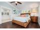 Peaceful bedroom with wicker bed frame and ensuite bath at 116 50Th St, Holmes Beach, FL 34217