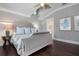 Spacious bedroom with a large bed, dark hardwood floors, and a view of another bathroom at 116 50Th St, Holmes Beach, FL 34217