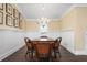 Elegant dining room features a chandelier and a wood table with four chairs at 116 50Th St, Holmes Beach, FL 34217