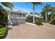 Two-car garage and long brick paver driveway leading to the home at 116 50Th St, Holmes Beach, FL 34217