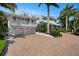 Two-car garage and long brick paver driveway leading to the home at 116 50Th St, Holmes Beach, FL 34217