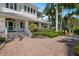 Inviting front porch with a teal door and brick paver walkway at 116 50Th St, Holmes Beach, FL 34217