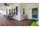 Front porch with rocking chairs, a small table and chairs, and a porch swing at 116 50Th St, Holmes Beach, FL 34217