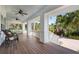 Large front porch with rocking chairs, a porch swing, and view of the landscaping at 116 50Th St, Holmes Beach, FL 34217
