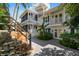 Two-story home with a spiral staircase and lush landscaping at 116 50Th St, Holmes Beach, FL 34217
