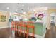 Kitchen island with orange barstools and teal accents at 116 50Th St, Holmes Beach, FL 34217