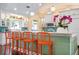 Kitchen island with teal accents and orange bar stools at 116 50Th St, Holmes Beach, FL 34217