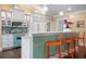 Bright kitchen with teal appliances and white cabinets at 116 50Th St, Holmes Beach, FL 34217