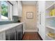White kitchen with teal accents, stainless steel appliances, and ample storage at 116 50Th St, Holmes Beach, FL 34217