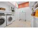 Bright laundry room with white cabinets and washer/dryer set at 116 50Th St, Holmes Beach, FL 34217