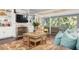 Living room with built-in shelving, fireplace, and view of screened porch at 116 50Th St, Holmes Beach, FL 34217