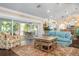 Bright living room with access to a screened porch and hardwood floors at 116 50Th St, Holmes Beach, FL 34217