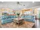 Light and airy living room with light blue sofas and wood coffee table at 116 50Th St, Holmes Beach, FL 34217