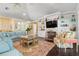 Spacious living room with built-in shelving, fireplace, and hardwood floors at 116 50Th St, Holmes Beach, FL 34217