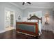 Main bedroom with hardwood floors and ensuite bathroom at 116 50Th St, Holmes Beach, FL 34217