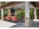 Stone fireplace and comfortable seating in covered patio at 116 50Th St, Holmes Beach, FL 34217