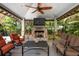 Covered patio with fireplace, comfortable seating, and a TV, ideal for outdoor relaxation at 116 50Th St, Holmes Beach, FL 34217