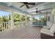 Relaxing porch with a swing, ceiling fan, and lush tropical views at 116 50Th St, Holmes Beach, FL 34217