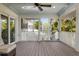 Screened porch with spiral staircase access and ceiling fan at 116 50Th St, Holmes Beach, FL 34217