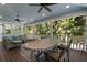 Relaxing screened porch with outdoor seating and lush landscaping at 116 50Th St, Holmes Beach, FL 34217