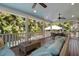 Spacious screened porch overlooking the pool and tropical foliage at 116 50Th St, Holmes Beach, FL 34217