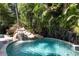 Waterfall feature in a lush, tropical backyard setting at 116 50Th St, Holmes Beach, FL 34217