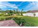 Landscaped backyard with grass, garden, and patio at 124 Giralda Ne Blvd, St Petersburg, FL 33704