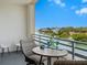 Relaxing balcony with water views and patio furniture at 1709 N Tamiami Trl # A421, Sarasota, FL 34234