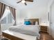 Bright bedroom with comfortable bed and wood accents at 1709 N Tamiami Trl # A421, Sarasota, FL 34234