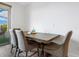 Simple dining area with four chairs and a wood table at 1709 N Tamiami Trl # A421, Sarasota, FL 34234