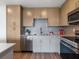 Modern kitchen with stainless steel appliances and wood cabinets at 1709 N Tamiami Trl # A421, Sarasota, FL 34234