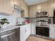 Modern kitchen with stainless steel appliances and wood cabinets at 1709 N Tamiami Trl # A421, Sarasota, FL 34234