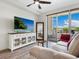 Living area featuring a large TV and comfy seating at 1709 N Tamiami Trl # A421, Sarasota, FL 34234