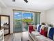 Living room with sliding doors to balcony and comfortable seating at 1709 N Tamiami Trl # A421, Sarasota, FL 34234