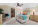 Spacious bedroom with wood dresser, ceiling fan, and large window at 1805 Datura St, Sarasota, FL 34239