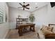 Home office with wood desk, built-in shelving, and hardwood floors at 1805 Datura St, Sarasota, FL 34239