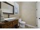 Elegant powder room with a vessel sink, decorative mirror, and updated fixtures at 1805 Datura St, Sarasota, FL 34239