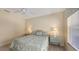 Comfortable bedroom with a queen-size bed, neutral decor, and window at 1908 Scarlett Ave, North Port, FL 34289